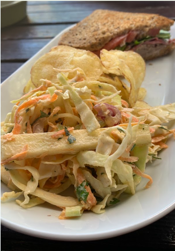 A sandwich, crisps and coleslaw plate